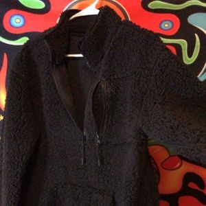 A thick cropped jacket. All black.